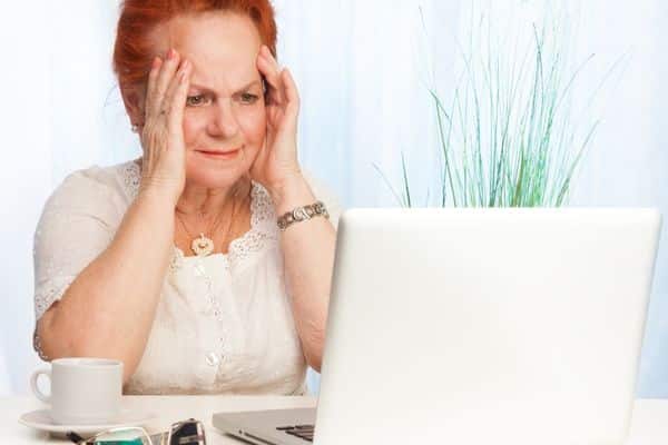 older woman looking at laptop.